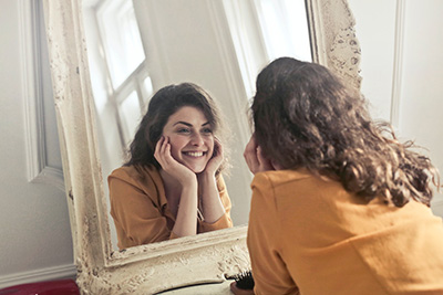 women smiling in mirror
